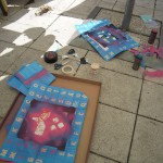 Spraypainting the boxes with stencils
