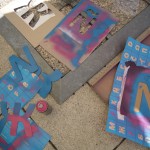 Spraypainting the boxes with stencils