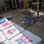 Spraypainting the boxes with stencils